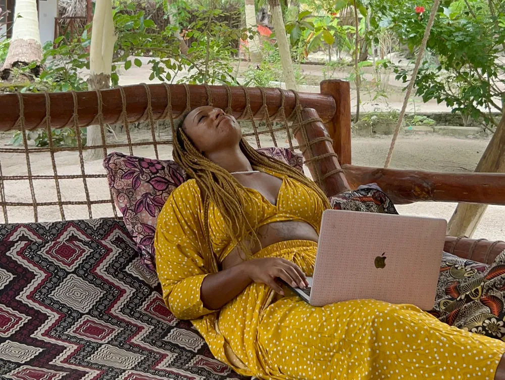 A founder slumped back in a chair, head in hands, laptop closed in front of them, conveying the burnout and full stop that isolation can bring to a project